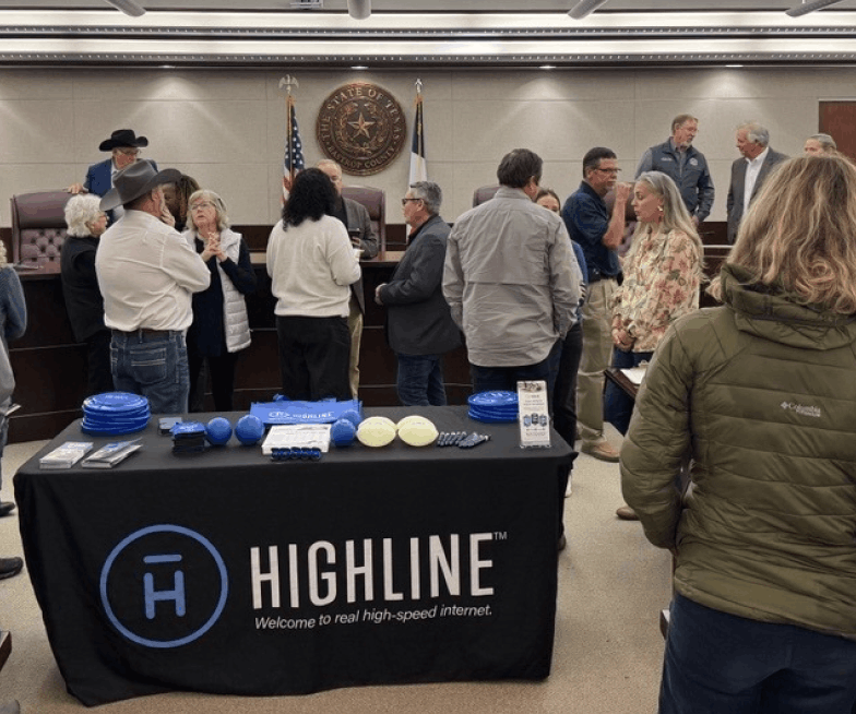 Highline booth inside town hall with people standing nearby