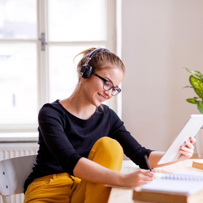 Photo of young woman in home office