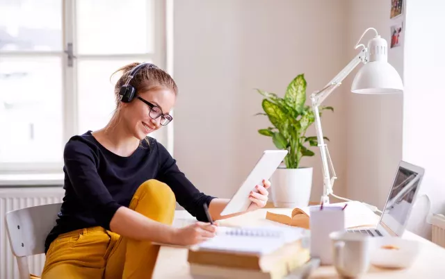Photo of young woman working in home office