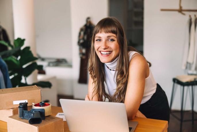 Woman smiling at laptop