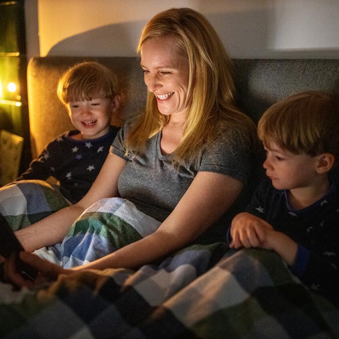 Woman watching TV with kids