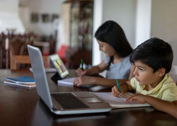Photo of two young kids studying