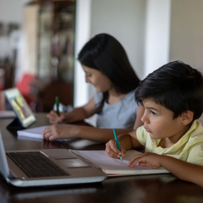 Photo of two young kids studying