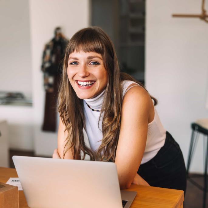 Woman smiling at laptop